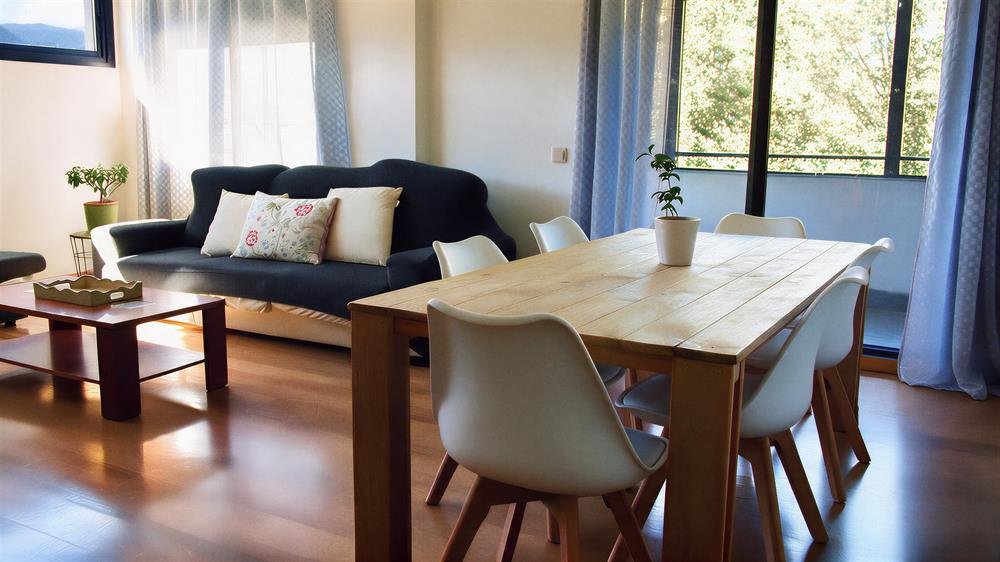 Salón y comedor del apartamento, con mesa para seis y sofá